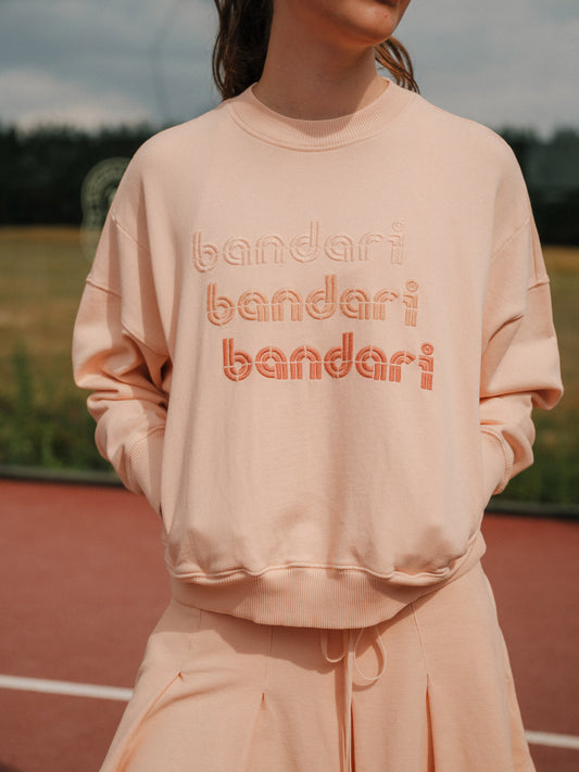 Bandari padel sweatshirt in Faded Peach - women's organic cotton loopback jersey, 3 tone embroidery, front view